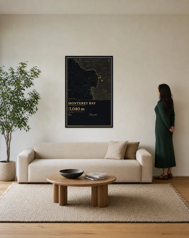 Generated scene: a living room, above a linen sofa. On the wall, our real Gilt drawing of Monterey Bay at 32 × 48 in, set at true scale beside a woman 5 ft 6 in tall.